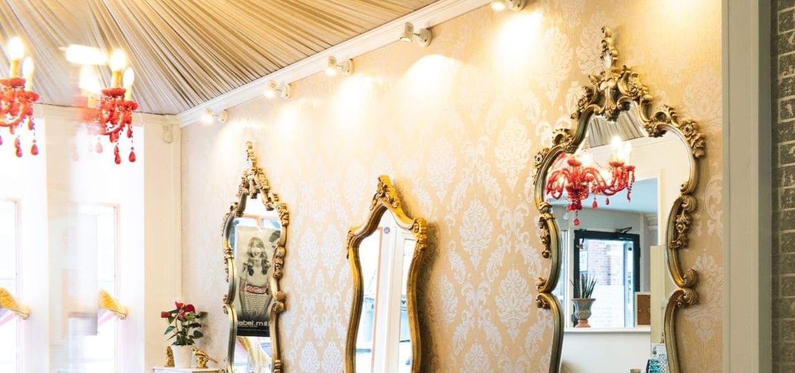 Serenity's salon floor with gold mirrors and chandeliers