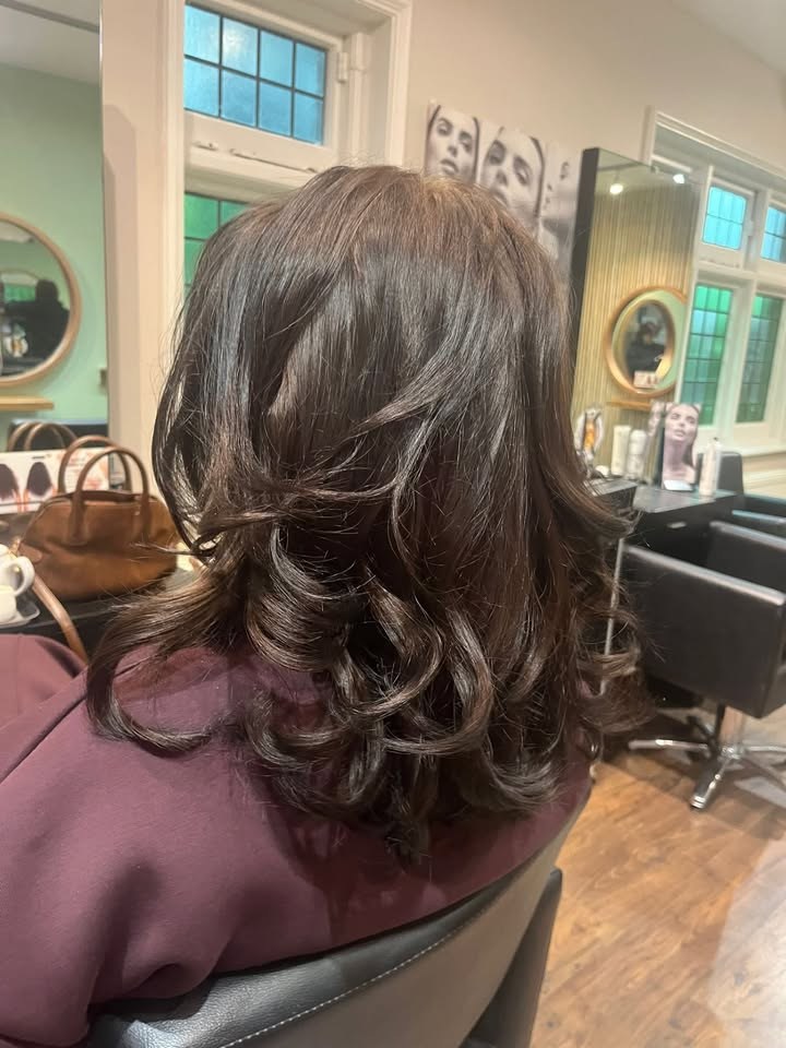 Rich brunette with soft curls, styled in the salon